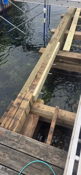 Close view of a timber stringer and its through-bolted connection