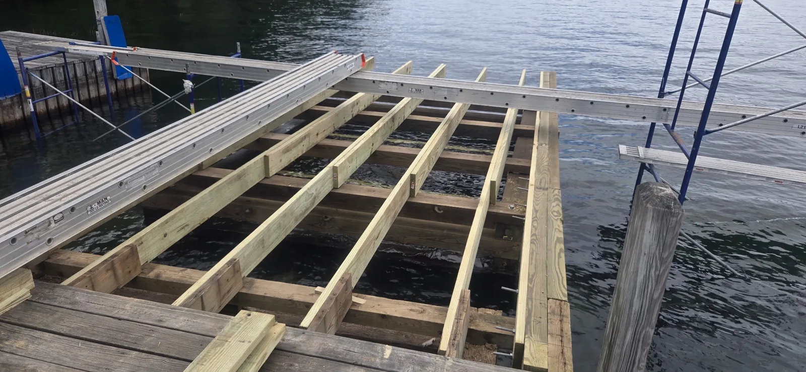 New timber stringers and cross-members over a crib dock, with staging alongside