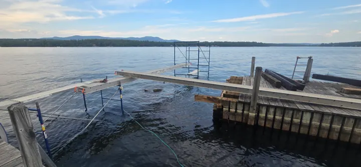 Work platforms and staging beside the opened timber crib dock