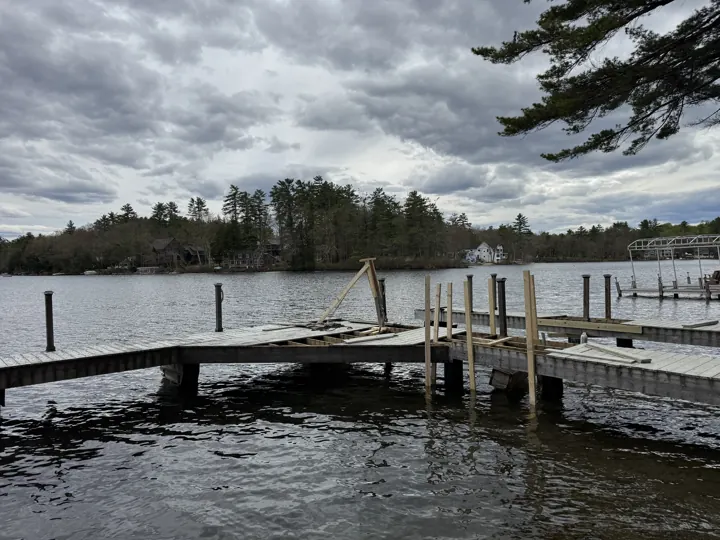Timber lifting frame set above an opened section of the gray dock