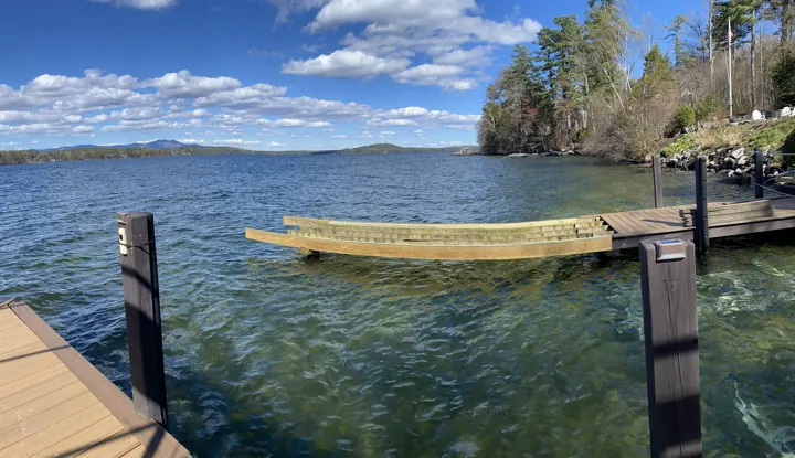 New timber stringers running from the dock toward the shoreline