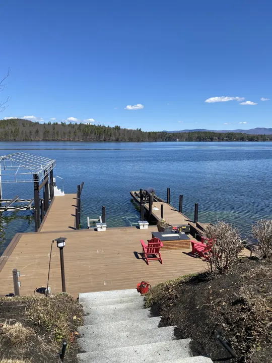 Stone stairs leading from shore down to a brown dock