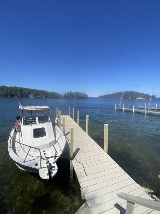 Boat alongside a dock with new timber posts and a swim ladder