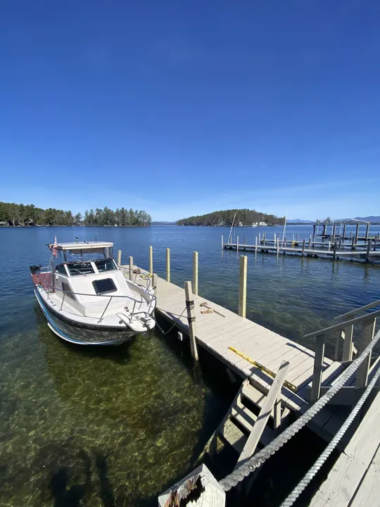 New dock posts beside a boat with a builder’s level laid on the deck
